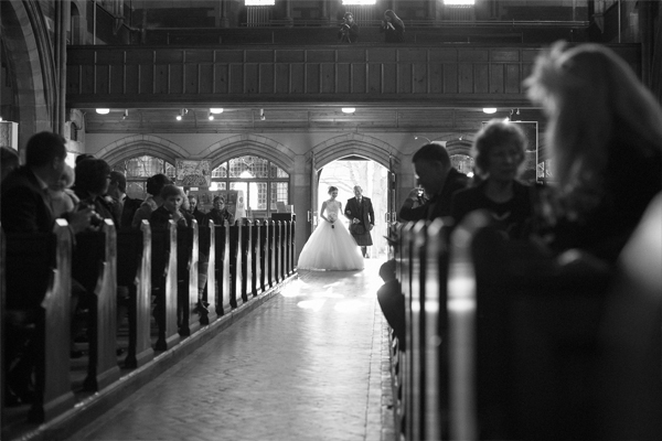 bride walking down the aisle with father in church wedding