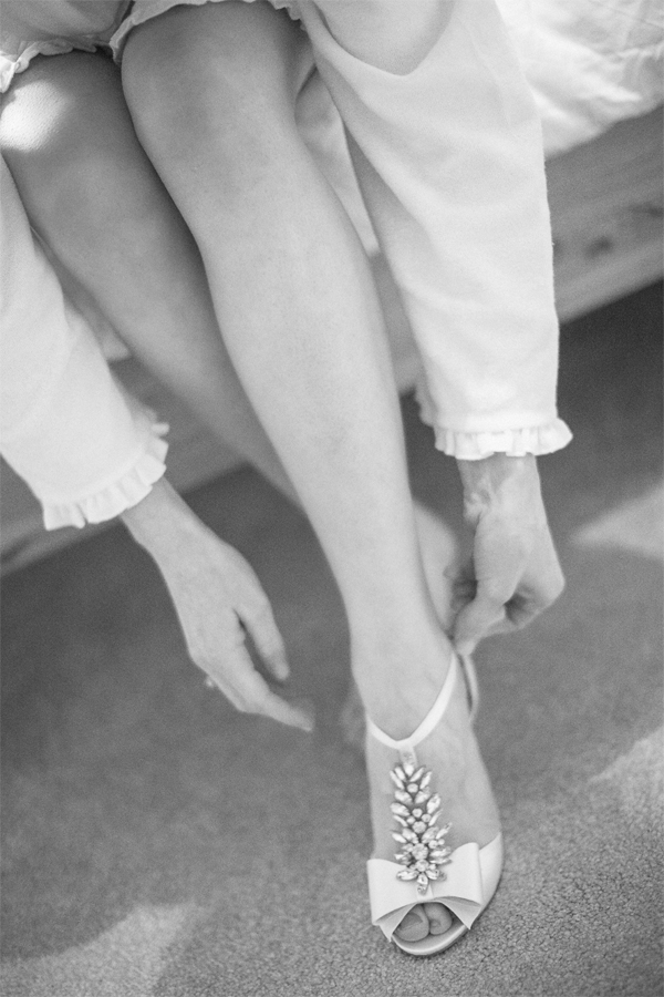 bride putting her shoes on 