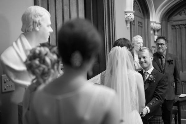 groom looking at bride during ceremony