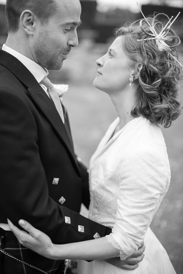 wedding photographer edinburgh bride and groom looking at each other embraced 
