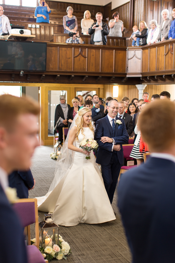 bride walking down the aisle in the hamilton church scotland 