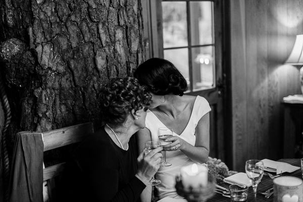 bride and mother wispering to each other 
