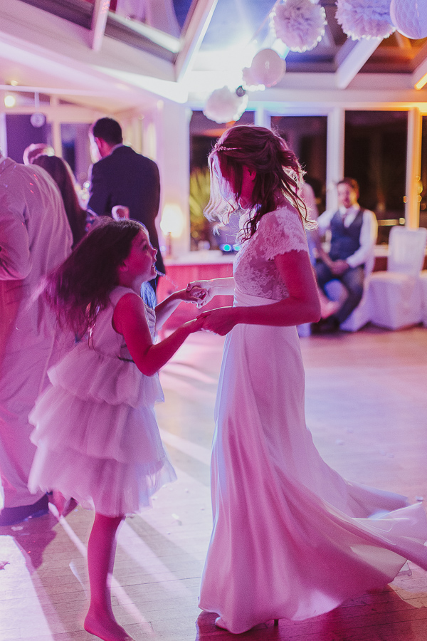 bride with flower girl dancing 
