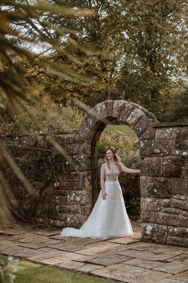 bride loooking towards the groom in the gardens of Glenapp Castle Estate